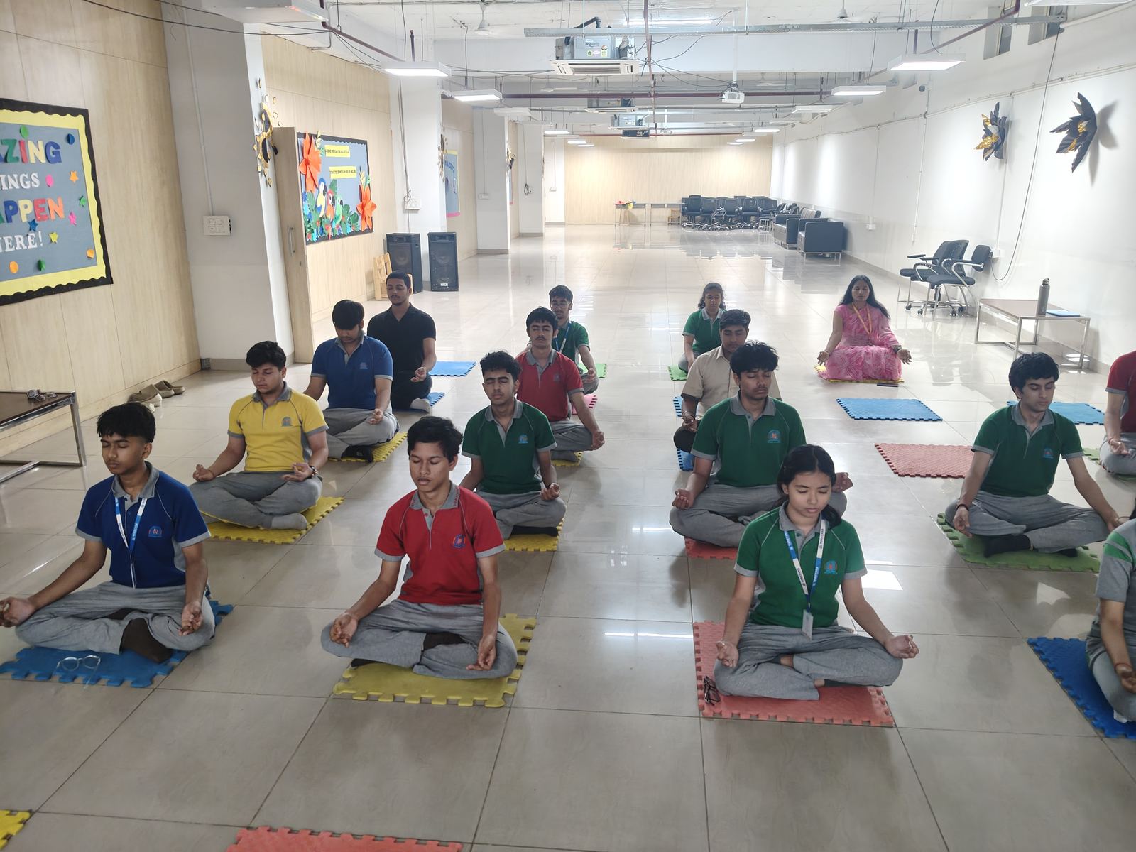 School students practising yoga together